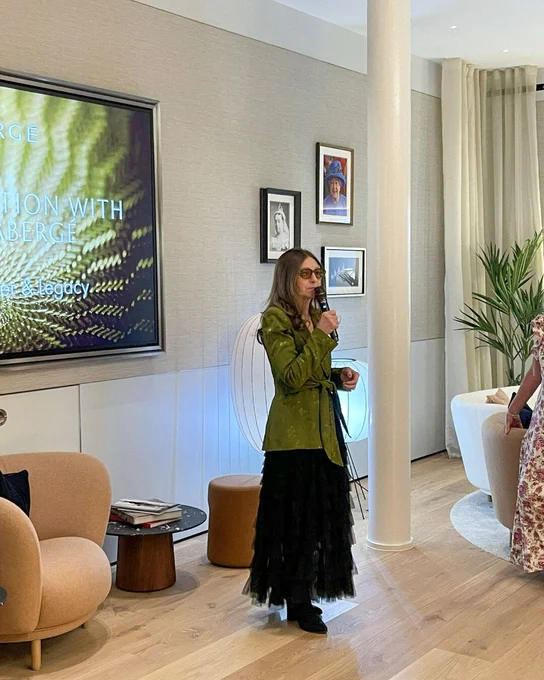 Speaker presenting at an in-store event with Fabergé display screen behind.