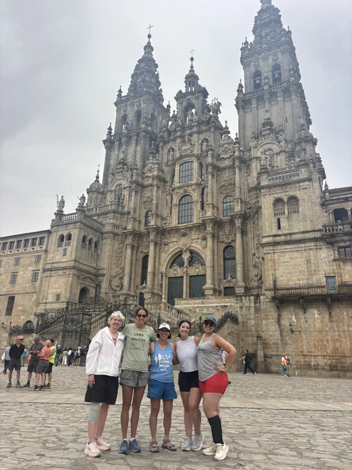 Five pilgrims in front of church