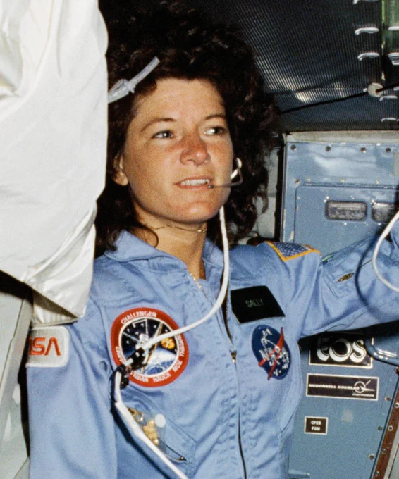 STS-7 mission specialist Sally Ride wears a light blue flight suit and a communications headset while aboard Challenger in June 1983.
