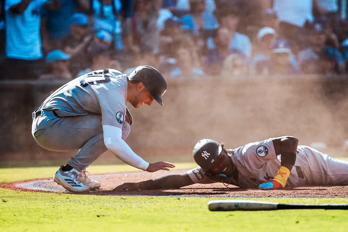 Max Schuemann checks on Jazz Chisholm Jr. after he slides home.