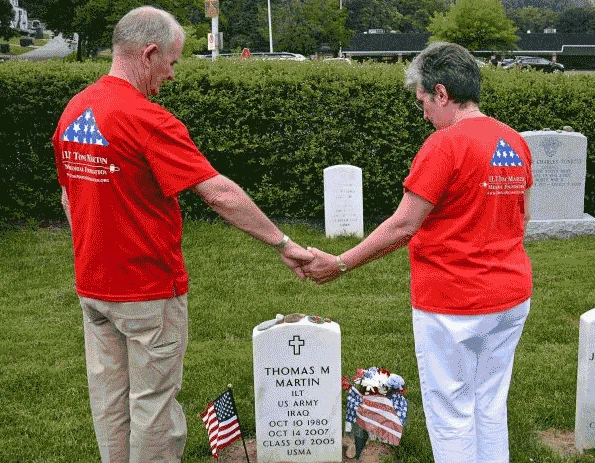 Two of Thomas Michael Martin's loved ones stand near his gravestone, holding hands. Thomas Michael Martin Collection #113364. Courtesy of the Martin Family.