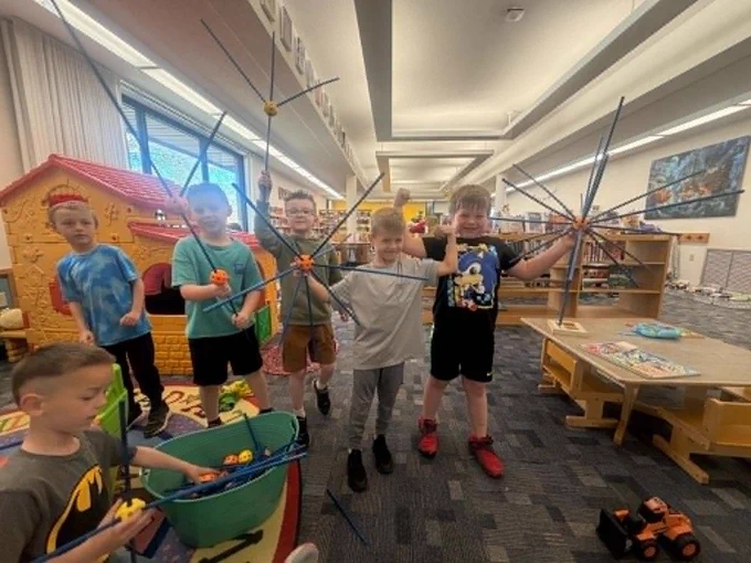 kindergartners built a sphere our of sticks at tehe library