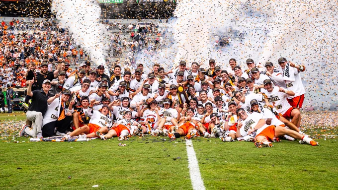 Team photo on the field with confetti in the back