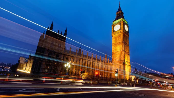 Traffic on Westminster Bridge passing Big Ben in London.
