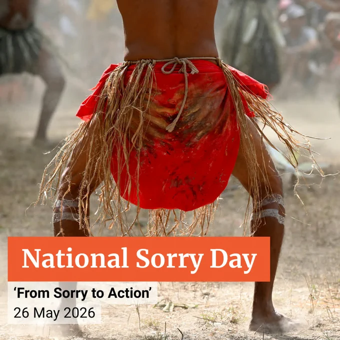 Indigenous man doing a traditional dance wearing traditional ceremonial costume