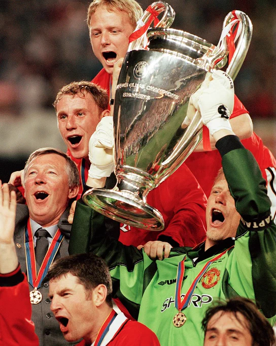 Peter Schmeichel lifts the trophy after winning the UEFA Champions League final against Bayern Munich at Camp Nou on May 26, 1999.