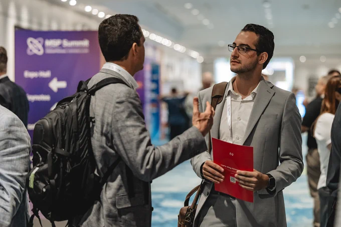 Two men connecting at MSP Summit, in deep conversation