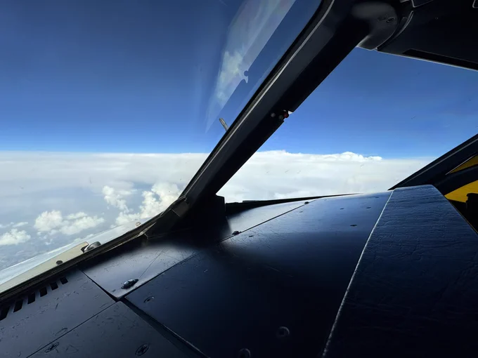 View out of the flight deck towards the right, with the top of a cumulonimbus (thunderstorm) visible.