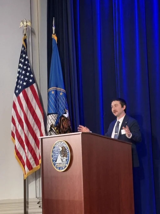 David O'Keefe delivers remarks on stage at the event.