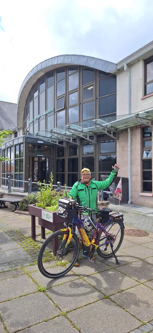 Timmy Mallet with his bike outside Orkney Library and Archive 