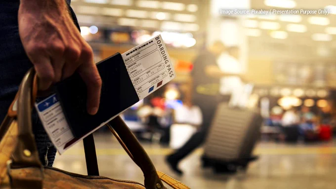 Traveler holding passport and boarding pass inside an international airport terminal before immigration screening. The image represents common immigration check mistakes international travelers make before flights, including passport validity issues, visa verification problems, missing hotel booking confirmations, transit visa confusion, and travel document organization. Airport immigration procedures in 2026 have become stricter with additional identity verification and travel screening requirements. The scene reflects the stress many first-time international travelers experience while preparing for passport control, airport security, and border entry checks. Useful visual for articles about immigration delays, international travel preparation, airport procedures, and avoiding immigration questioning during overseas trips.