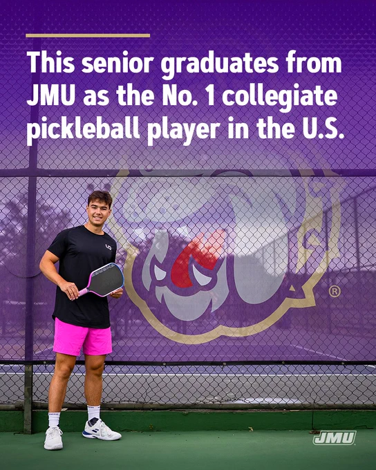 Inforaphic showing a JMU pickleball player standing on a court in front of a large purple fence banner with the JMU Duke Dog logo. The player is holding a paddle and wearing a dark shirt, bright pink shorts, white shoes, and white socks. Large white text at the top reads: “This senior graduates from JMU as the No. 1 collegiate pickleball player in the U.S.” The JMU logo appears in the bottom right corner.