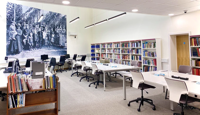 Shown here is a photograph of the Search Room at Kent Archives. We're based at Kent History and Library Centre on James Whatman Way, Maidstone.

Our Search Room is equipped with climate controls designed to preserve our collections whilst they are being accessed by the public, with the added bonus of keeping the space pleasantly cool during the summer months.

We’re open to the public from 9am to 5pm, Tuesday to Saturday. Documents can be ordered until 4pm, and we kindly ask that anything being viewed is returned to the Search Room Supervisor no later than 4:45pm, ensuring our team has enough time to return items to the strong rooms before closing.

We advise booking a desk to avoid disappointment. However, we are happy to accommodate non‑booked readers if space allows.

To book your visit, contact us at archives@kent.gov.uk — we’ll be happy to check our desk availability and guide you through the process of being authorised to access our collections.