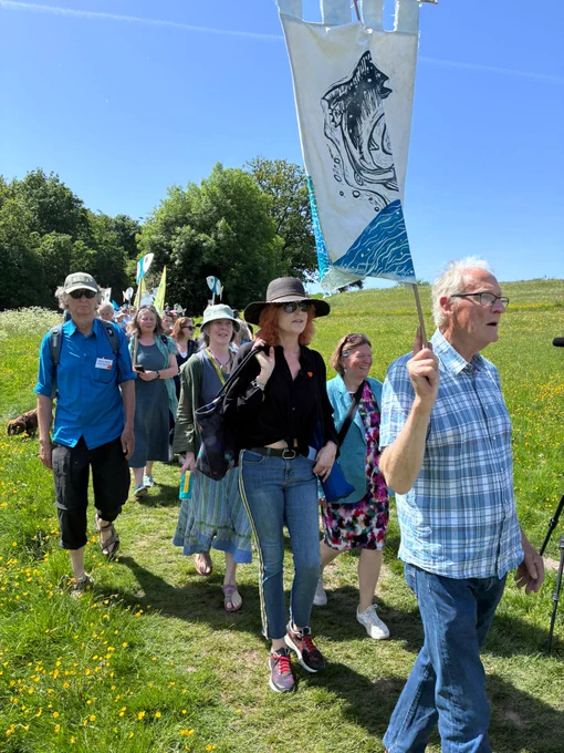 Ellie smiling with a group as they walk to the River for the launch of the Charter