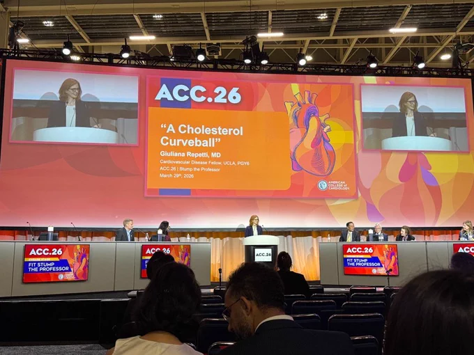 A speaker presents at American College of Cardiology Scientific Sessions 2026 on a large stage, with screens displaying the talk title “A Cholesterol Curveball” by Giuliana Repetti, MD, during the “Fit Stump the Professor” session.