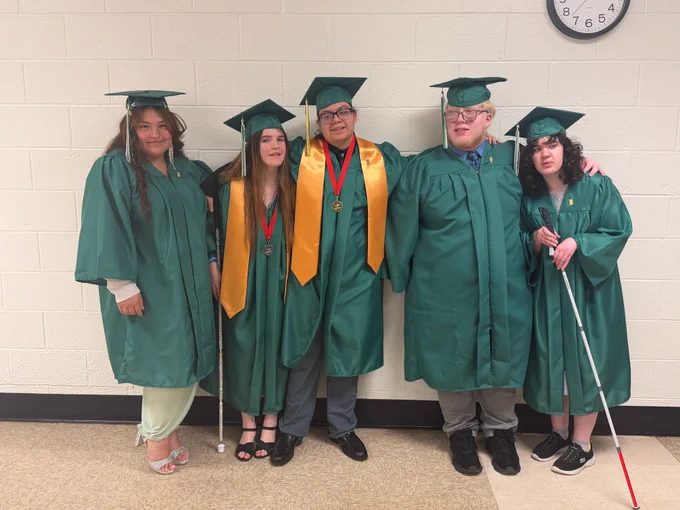 The ISBVI class of 2026 poses for a group photo in their caps and gowns. From left to right: Angelina, Jazmine, Andrea, Santi, and Riley.
