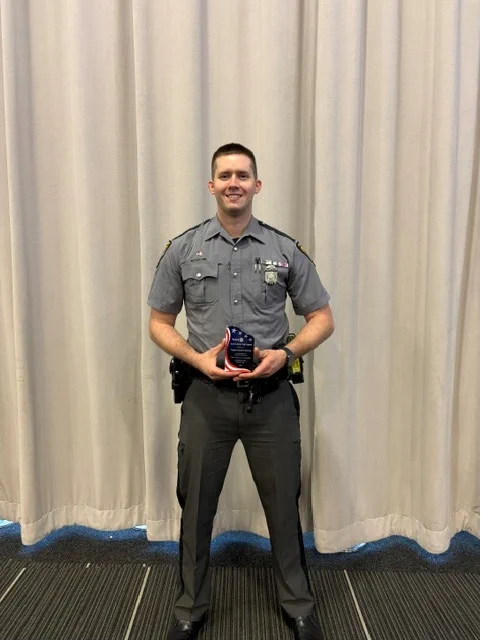 Trooper Shelton holding Service Above Self Award. 