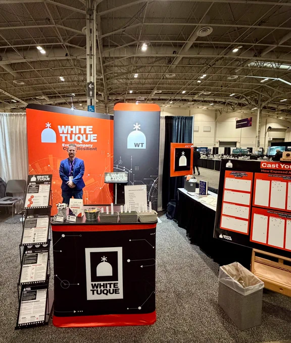 Booth set up at a convention centre. White Tuque company logo is displayed. 