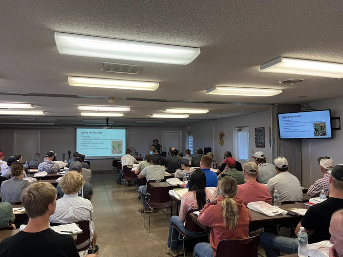 Many people in a classroom watching a presentation about crop scouting.