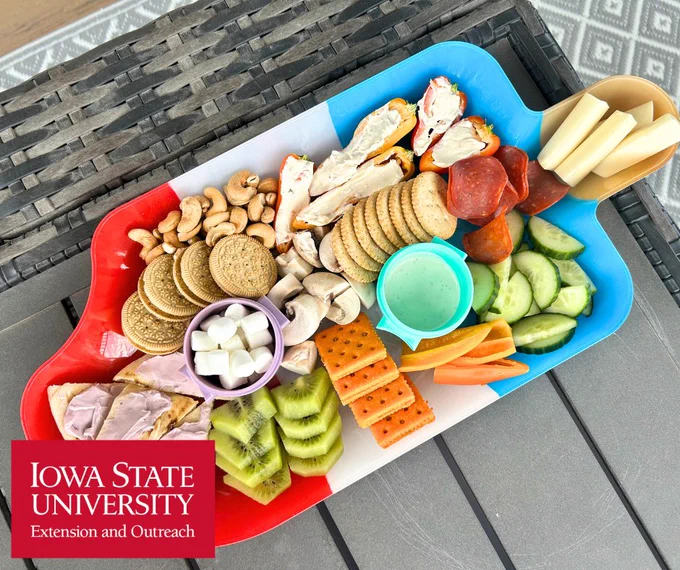 snack board spread for kids on a popsicle shaped platter