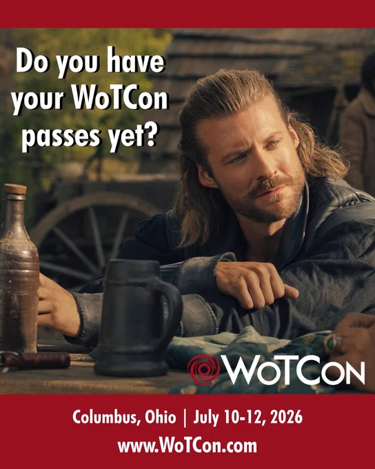 picture of Taylor Napier as Maksim the Warder in the wheel of time, sitting at a table in the Two Rivers with his arms crossed, his blonde shoulder-length hair half up, and a mug in front of him, looking seriously over at someone. Caption reads do you have your WoTCon passes yet? Columbus, Ohio July 10-12, 2026 www.wotcon.com. The WoTCon logo with the red swirling circle is in the bottom right corner of the image