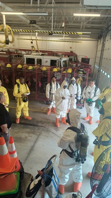 people in hazmat suits receiving instruction at the hazmat training center