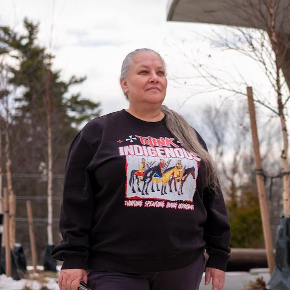 Portrait of Tanya Senk in front of the Indigenous House.
