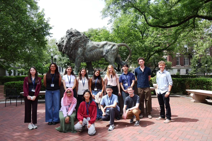 The 2026 SRP interns stand in front of the lion statue