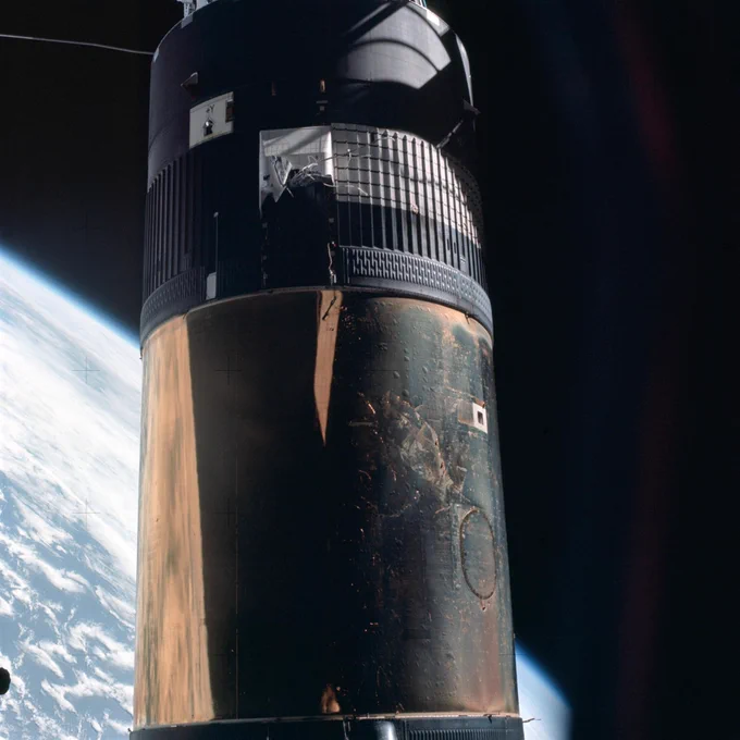 View of Skylab's Orbital Workshop on May 25, 1973 as seen by the Skylab 2 crew. One of its shiny shields is missing from its right side. Earth's limb is visible in the background.
