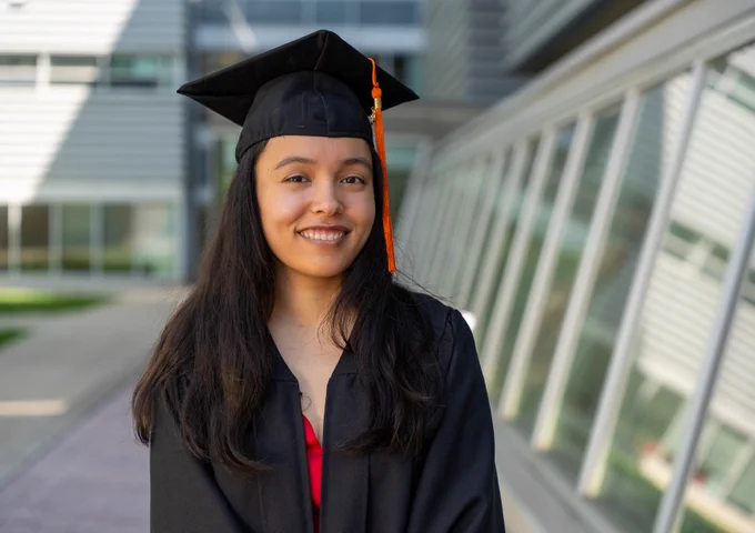 Hannah smiling in her cap and gown
