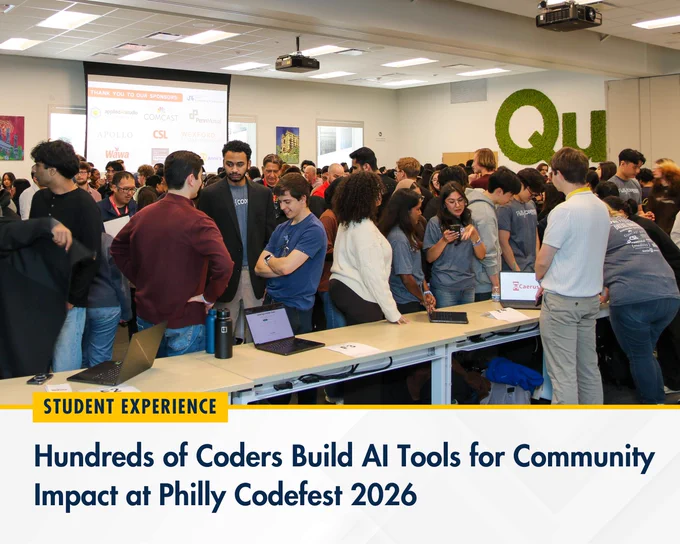 A large group of coders gathers in a bright conference room at Philly Codefest 2026, collaborating on AI tools for community impact.