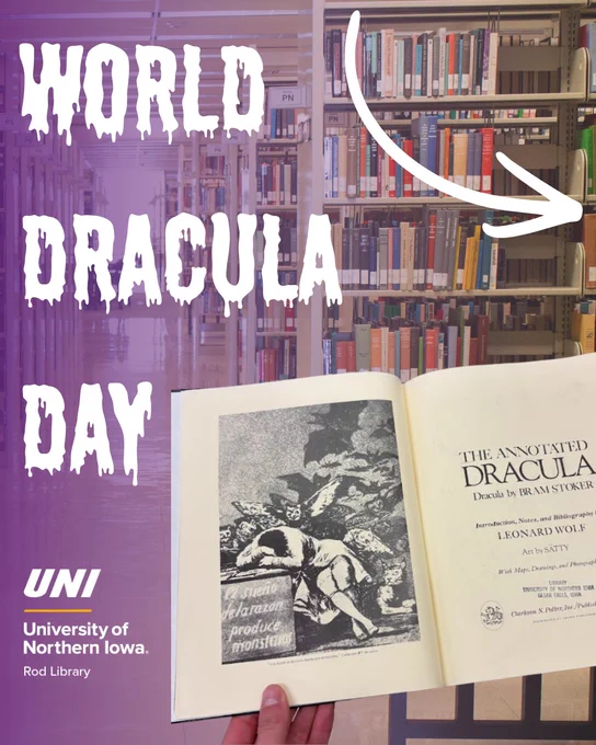 Open book showing the title page and illustration of Bram Stoker's Dracula in a library setting with shelves of books in the background.