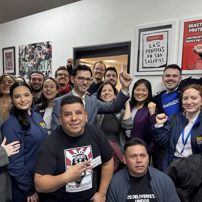 D C W P Commissioner Levine celebrates with D C W P team members and members of Los Deliveristas Unidos.