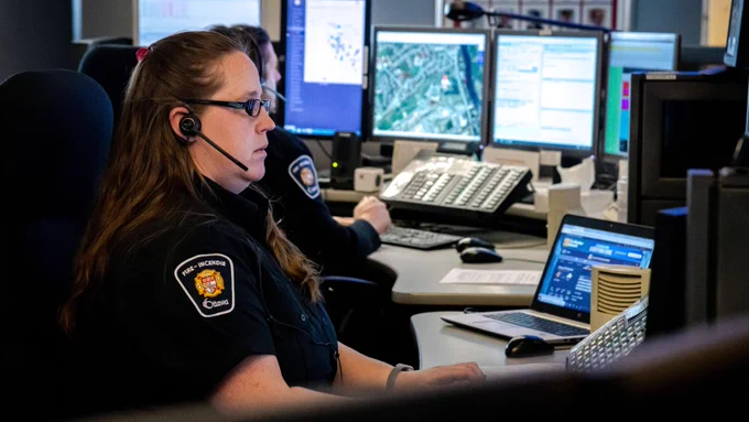 Ottawa Fire Services communication officers at their desks responding to 9-1-1 calls.