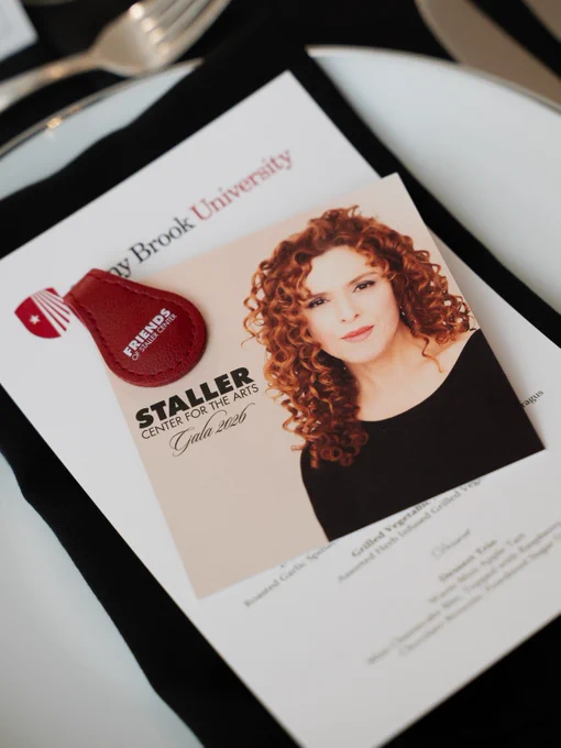 A picture of the table setup for the 2026 Staller Center Gala, featuring a picture of Bernadetter Peters.
