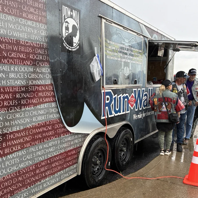 A shot of a large trailer with the words "Run for the Wall". It has the logo for Prisoners of War/Missing in Action and lists names of military members on the side.