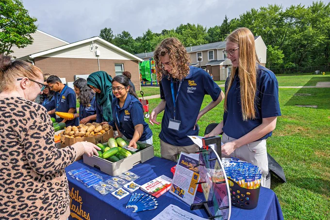 Mobile Flashes students providing fresh produce during a community event.