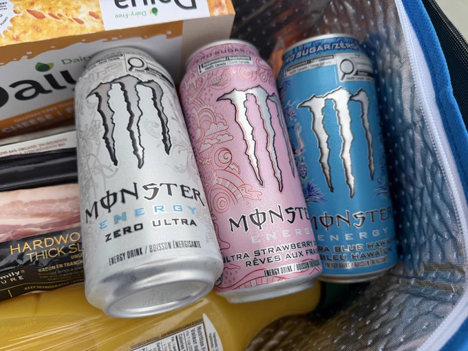 monster energy on top of my groceries. white pink and blue flavors