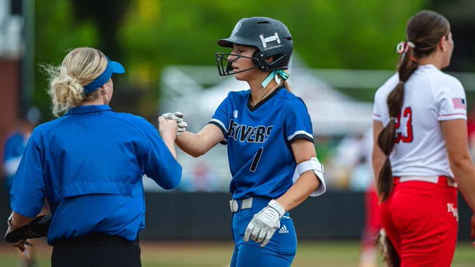 Keinlee Rinacke fist bumps Assistant Coach Gabby Schultz following a base hit against Northwest Florida at the NJCAA D1 Softball National Tournament in Oxford, AL.