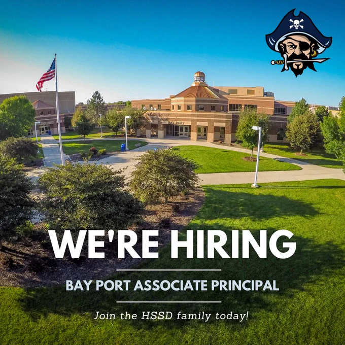 Exterior view of Bay Port school building with American flag and green lawn under clear blue sky, promoting associate principal hiring.