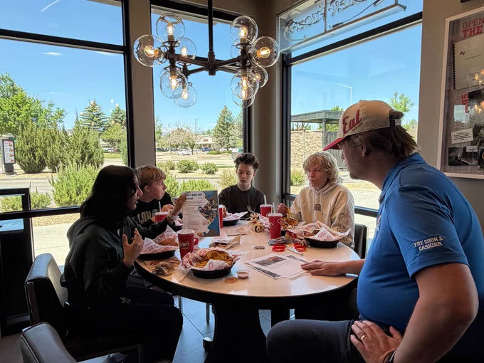 Students meet with a Cane's employee