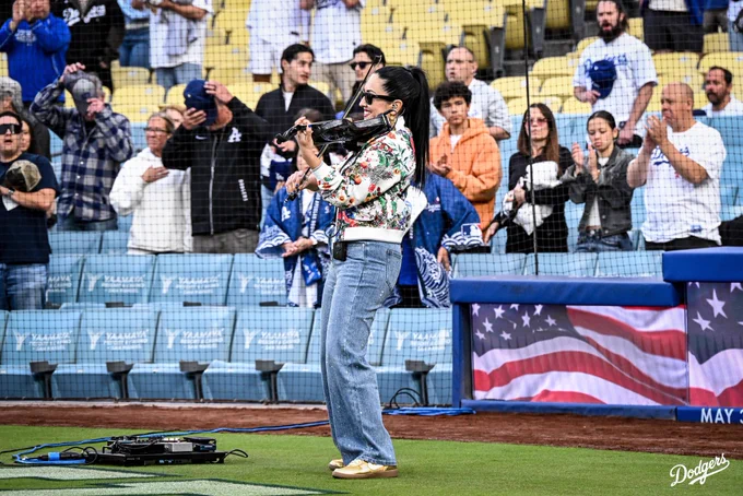 A photo of Suemy G playing the National Anthem on the violin on the field at UNIQLO Field at Dodger Stadium.