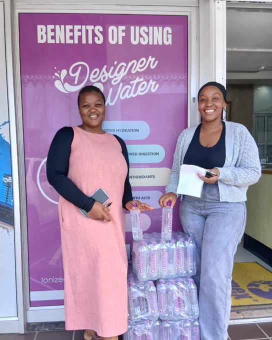 Picture of Nothando and a friend or family member collecting their Designer Water pH10 from the Master Distributor in Morningside, KZN.