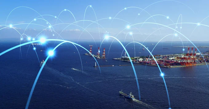 Ships and communication network concept with maritime traffic near port infrastructure. Source: iStock