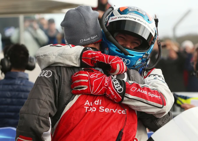 Marcel Fässler, clearly delighted even while still wearing his crash helmet, warmly hugs an unidentified Audi mechanic in parc ferme. 2015 6 Hours of Silverstone.