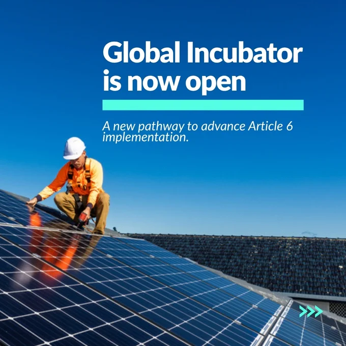 A person in a safety outfit works on solar panels under a clear blue sky. The text reads, "Global Incubator is now open. A new pathway to advance Article 6 implementation.