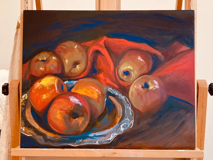 An oil painting of apples lying on a table with red fabric and a silver plate. They are arranged loosely together.