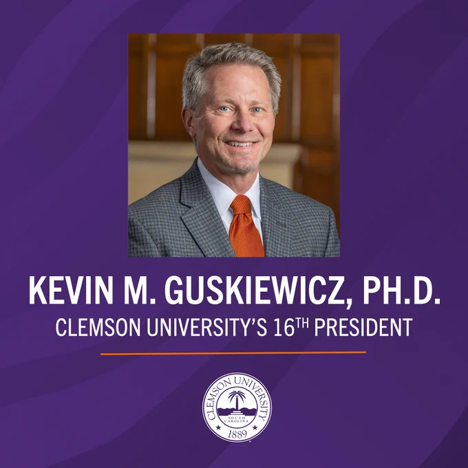 Image of a person in formal attire, smiling, with a purple background featuring the Clemson University seal. Text reads: "Kevin M. Guskiewicz, Ph.D. Clemson University's 16th President."