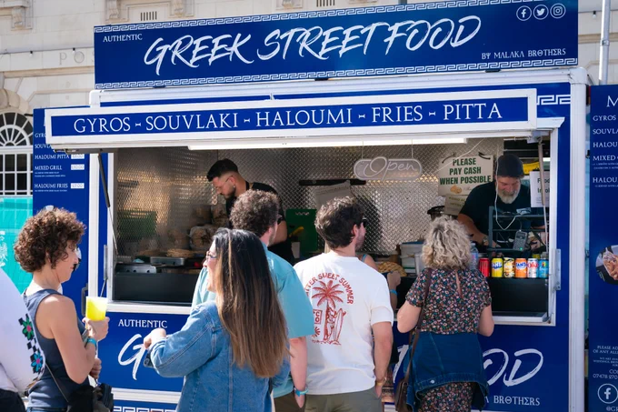 Greek Street Food van at a festival, serving customers 
