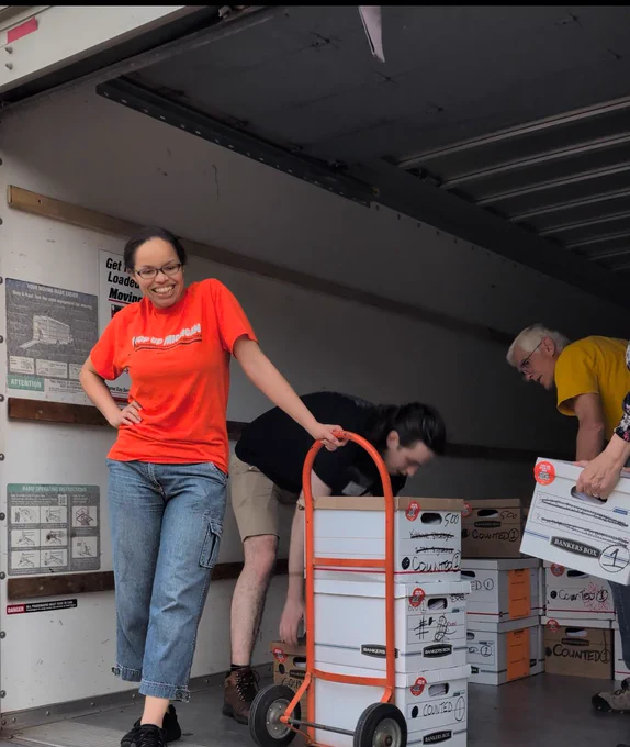Back of a U-Haul with folks loading boxes of petitions!
